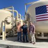 John Brundahl (left) production superintendent, Todd Colvin, chief water systems operator, and Mark Toy, general manager, run the nation's largest resin PFAS water treatment plant at the Yorba Linda Water District in Orange County, Calif. The three men stand in front of large filtration tanks at the treatment plant.