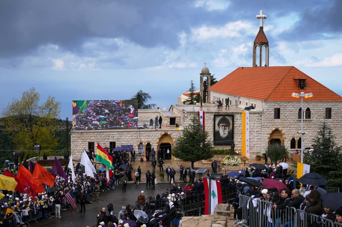 People wait outside the Monastery of Saint Maroun ahead of Pope Leo XIV's arrival in Annaya, Lebanon, Monday, Dec. 1, 2025. 