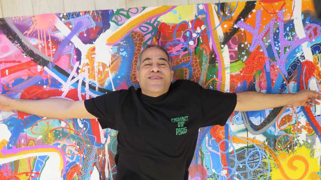 JonOne with one of the paintings featured in his sol show at Miami's Museum of Graffiti.