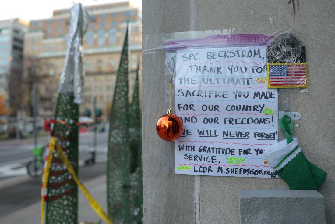 A makeshift memorial of flowers and American flags stands outside the Farragut West Metro station on Dec. 1 in Washington, D.C.