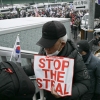 A supporter of impeached South Korean President Yoon Suk Yeol holds a placard reading "Stop the Steal" as he takes part in a rally near Yoon's residence in Seoul on Sunday.