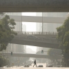 A person crosses a street as smog fills the air Wednesday, Dec. 4, 2024, in Los Angeles.