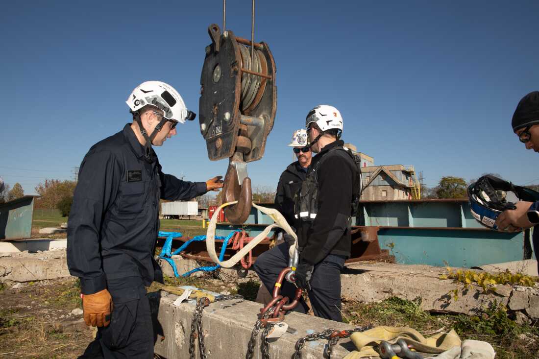 Search and rescue experts practice attaching a piece of concrete to a crane so it can be lifted out of the way