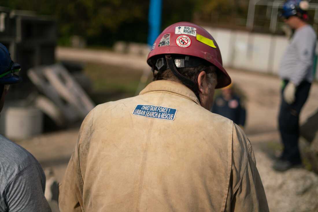 Longtime search and rescue expert Steven Schupert looks on as trainees practice using cranes to move debris.