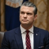 Secretary of Defense Pete Hegseth listens as President Donald Trump speaks during a Cabinet Meeting at the White House on Dec. 2.