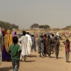 People who fled the Zamzam camp for the internally displaced after it fell under RSF control, walk in a makeshift encampment in an open field near the town of Tawila in war-torn Sudan's western Darfur region on April 13, 2025.