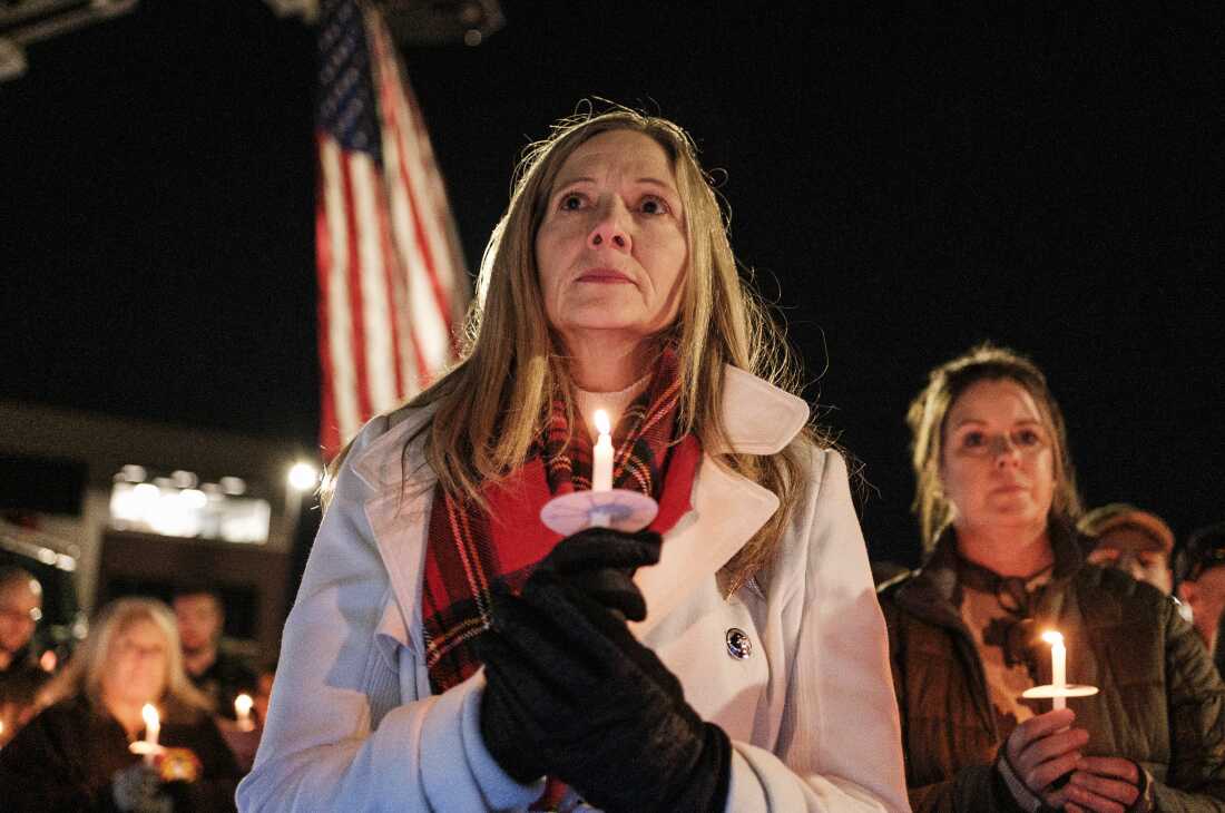 Members of the West Virginia public safety community attend a candlelight vigil for Staff Sgt. Andrew Wolfe outside of the Berkeley County Sheriff's office on Wednesday.