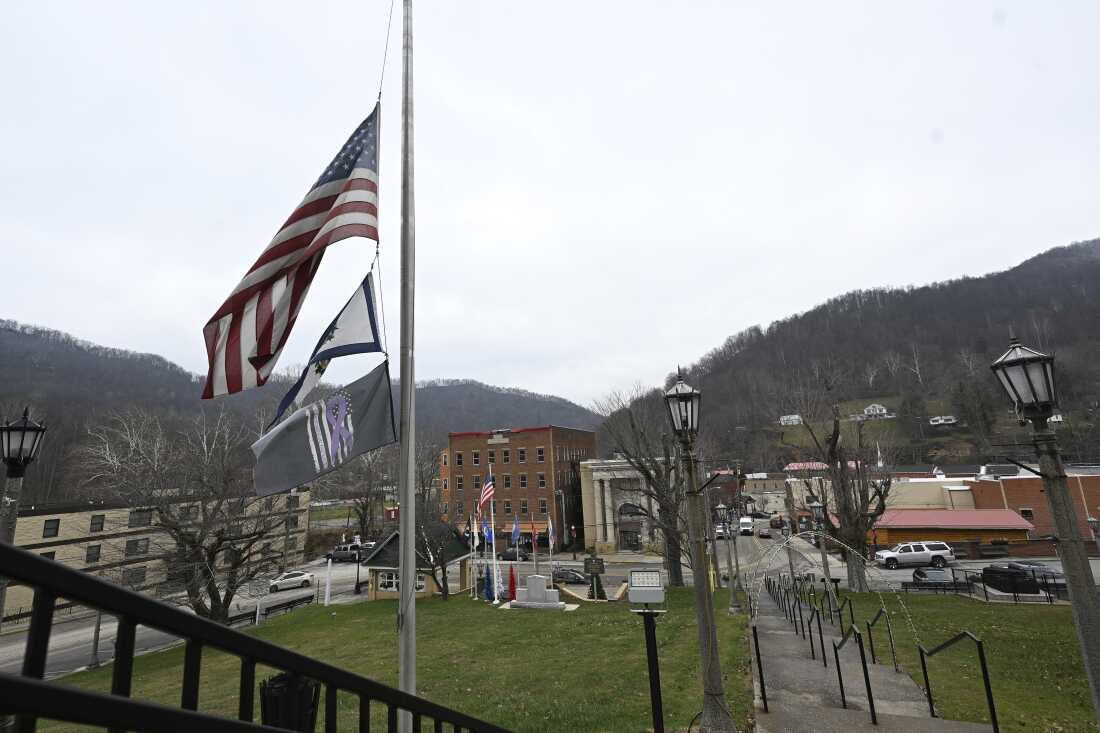Flags fly at half-staff for West Virginia National Guard Specialist Sarah Beckstrom at the Webster County Courthouse in Webster Springs, W.Va., on Wednesday.