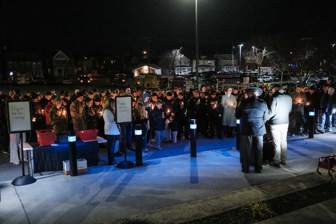 Members of the West Virginia public safety community attend a candlelight vigil for Staff Sgt. Andrew Wolfe outside of the Berkeley County Sheriff's office on Wednesday.