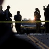 Members of law enforcement stand in the road, blocks from the White House, at the site where two West Virginia National Guard members were shot on November 26, 2025.