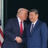 President Donald Trump, left, and Chinese President Xi Jinping, right, shake hands after their U.S.-China summit meeting at Gimhae International Airport Jinping in Busan, South Korea, Thursday, Oct. 30, 2025.