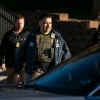 Federal law enforcement agents outside a metro Denver apartment complex during an immigration raid Feb. 5, 2025