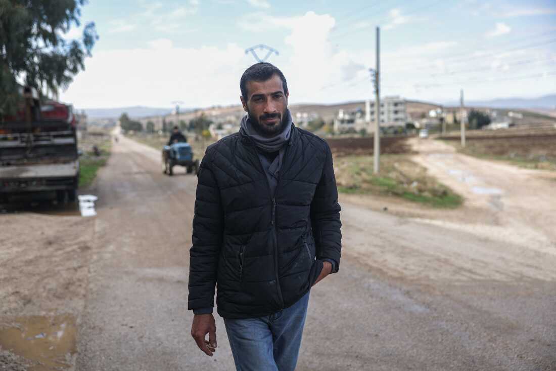 Former detainee Mohammad Marwan walks down a street on his way to the Homs Recovery Center in the village of Tell Dahab in the Homs countryside, Syria, Dec. 2.