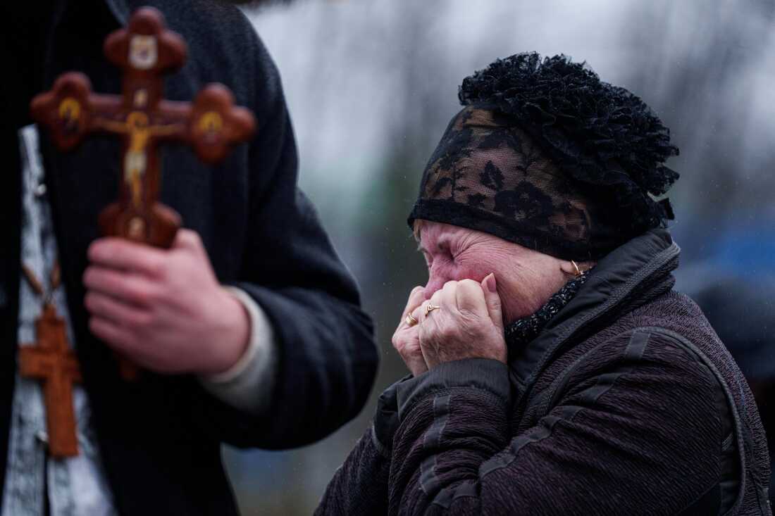 A mother cries in front of the coffin of her son Oleh Borovyk, a Ukrainian serviceman who was killed in fighting with Russian forces near Pokrovsk, during his funeral ceremony in Boiarka, Ukraine, on Wednesday, Dec. 3, 2025.  