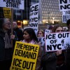 Demonstrators gather in a crowd holding signs that read things like "ICE out of NYC" and "No troops in NYC."