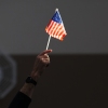 An election worker raises a U.S. flag while assisting voters at a polling station in Las Vegas on Election Day, Nov. 5, 2024.