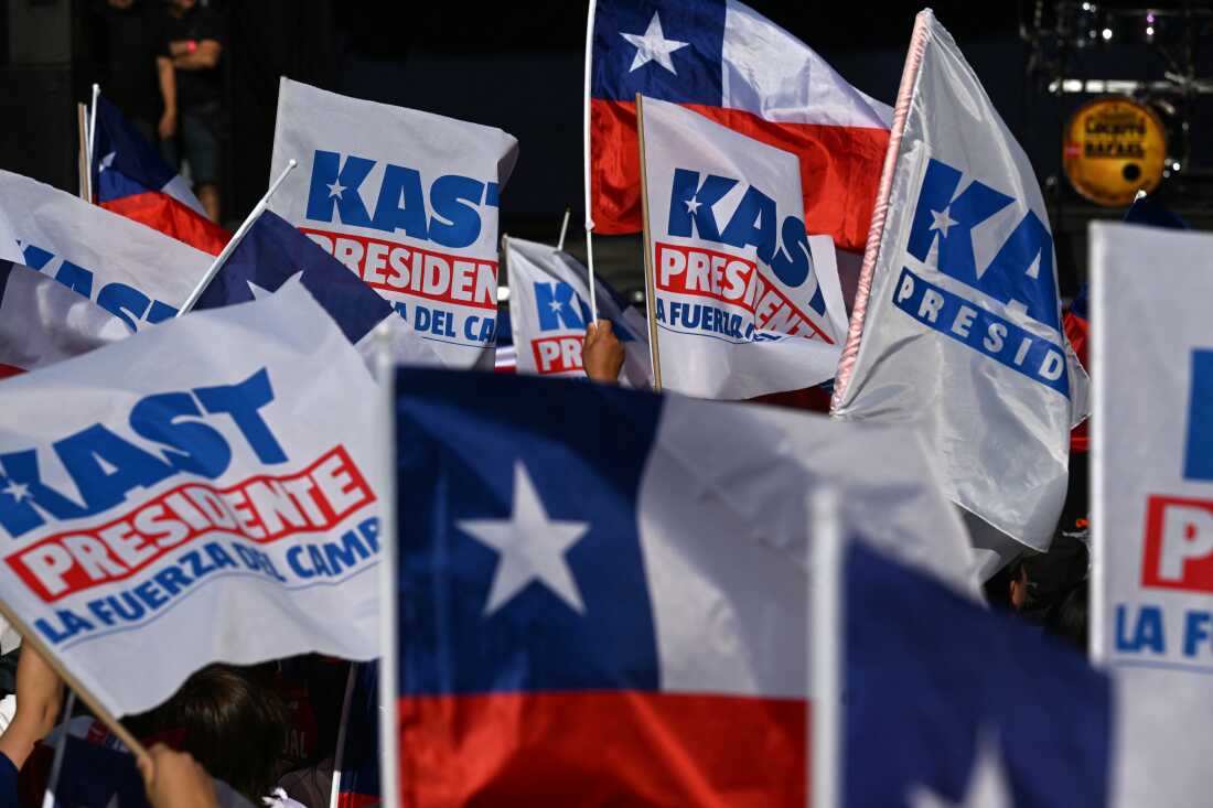Supporters of Chile's presidential candidate Jose Antonio Kast wave flags before the start of his closing campaign rally in Temuco, Chile, on Dec 11, 2025.