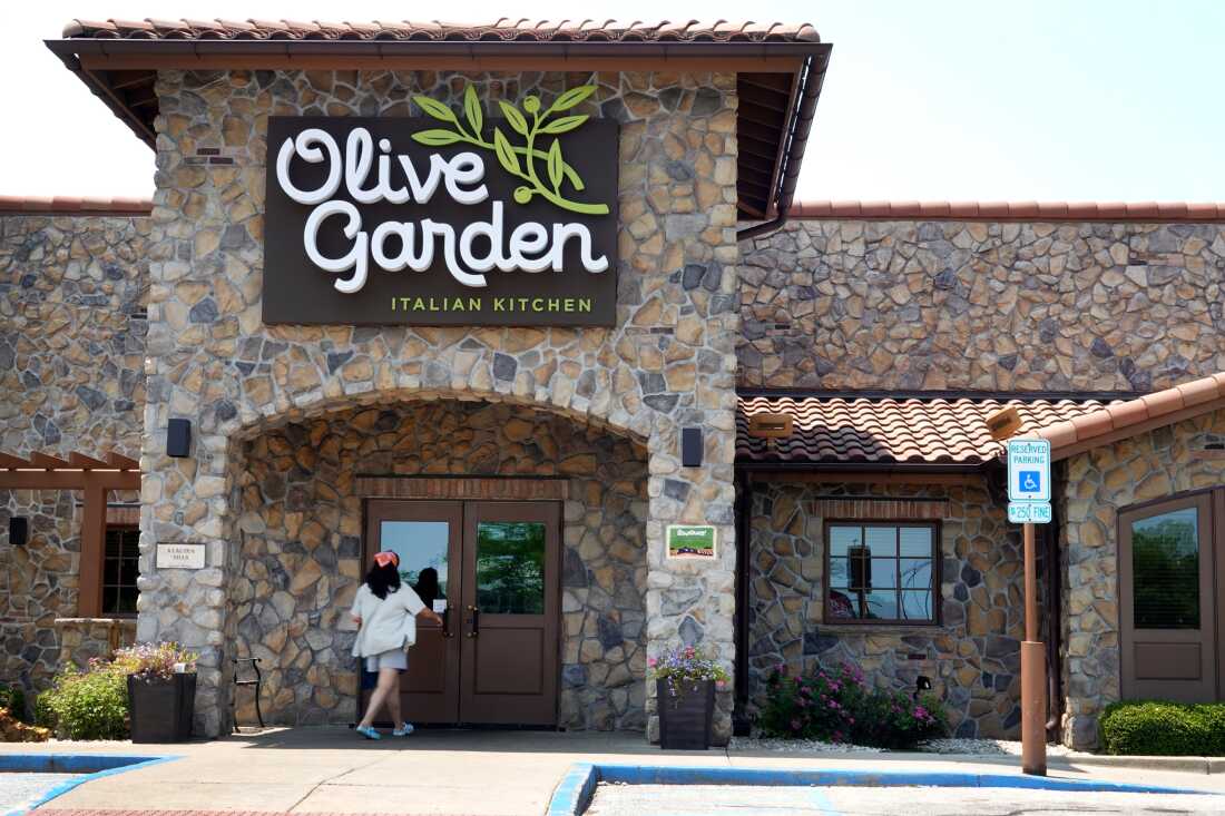 A person walks into an Olive Garden restaurant in Chicago in 2023.