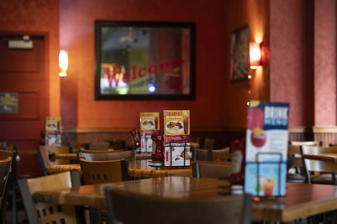 Empty tables are seen at Applebee's in Times Square.