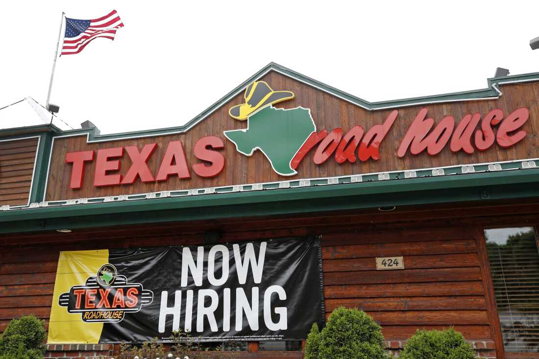A "Now Hiring" sign is displayed outside a Texas Roadhouse restaurant in Methuen, Mass., on June 5, 2020.