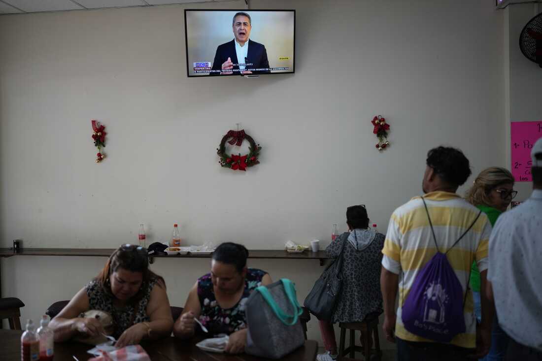 People in a coffee shop in Tegucigalpa, Honduras, watch a TikTok video of former President Juan Orlando Hernández publicly thanking U.S. President Donald Trump for pardoning him of drug trafficking and weapons charges.