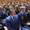 Defense Secretary Pete Hegseth, center, sitting with other senior military leaders, listen as President Trump speaks at Marine Corps Base Quantico in September 2025.