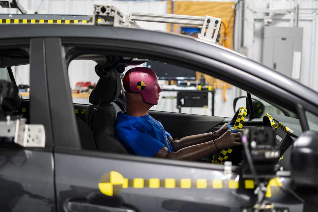 Crash-test dummies fitted with sensors are prepared for an impact test at the Insurance Institute for Highway Safety facility in Ruckersville, Va., on Tuesday, Dec. 2, 2025. Photographer: Carlos Bernate for NPR.