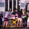Emergency workers transport a person on a stretcher after a reported shooting at Bondi Beach in Sydney, Sunday, Dec. 14, 2025.
