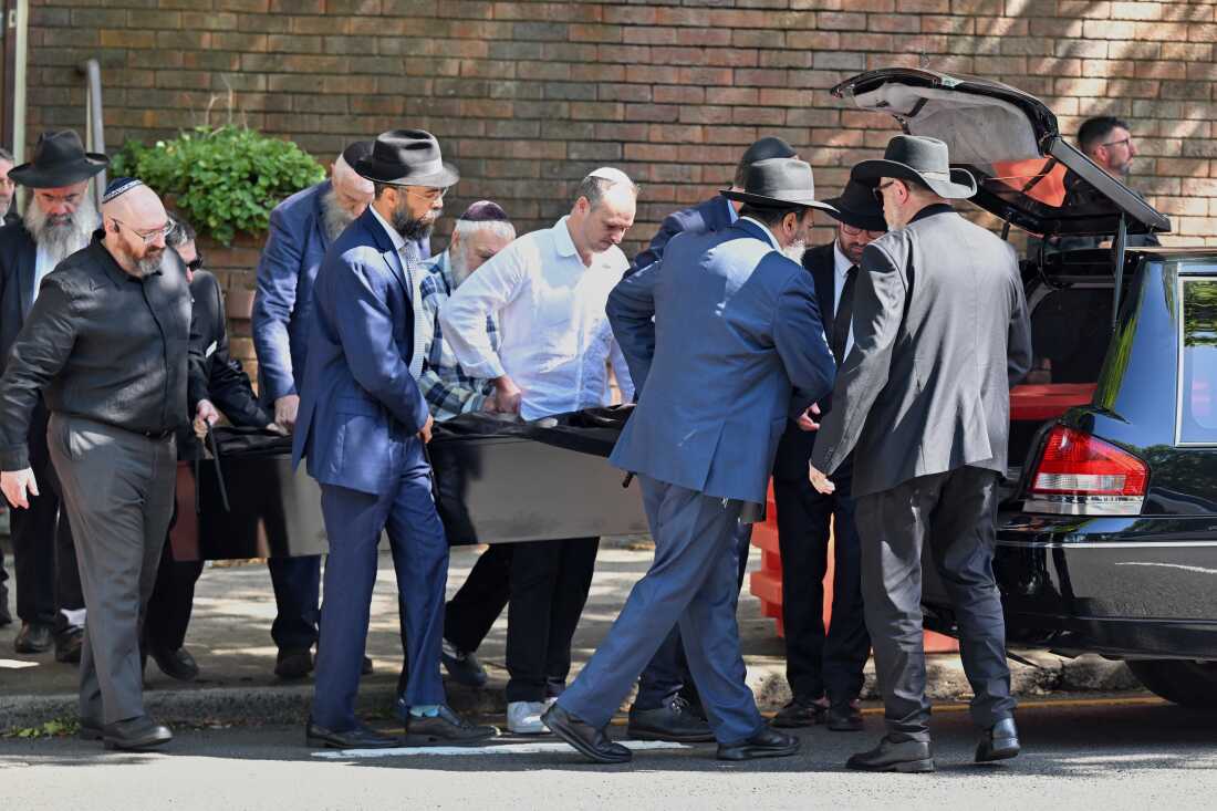 The casket is carried out during the funeral for Holocaust survivor and Bondi shooting victim, Alex Kleytman at Chevra Kadisha in Sydney, Thursday, Dec. 18, 2025.