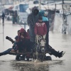 Palestinians cross a flooded street following heavy rain in Khan Younis, southern Gaza Strip, Dec. 11.