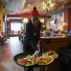 A server delivers food to a table at the world's largest Applebee's in New York City's Times Square.