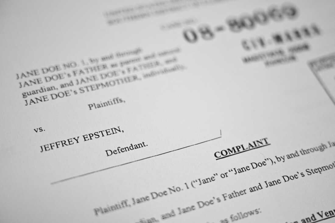 This photo illustration taken in Washington, DC, on Dec. 19, 2025 shows a court document after the Justice Department began releasing the long-awaited records from the investigation into the politically explosive case of convicted sex offender Jeffrey Epstein.