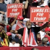 Supporters hold "Lumbees for Trump" signs as President Donald Trump speaks during a campaign rally at the Robeson County Fairgrounds in Lumberton, N.C.