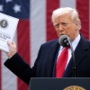 Trump holds up a report as he speaks at an event in the Rose Garden at the White House in Washington, D.C., on April 2, 2025.
