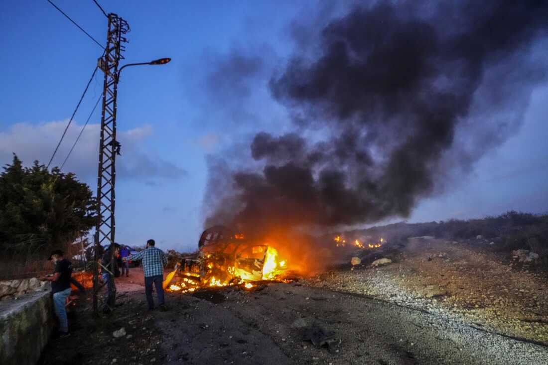 Qatar's Al-Jazeera TV car burns after it was hit by Israeli shelling in the Alma al-Shaab border village with Israel, South Lebanon on Oct. 13, 2023.