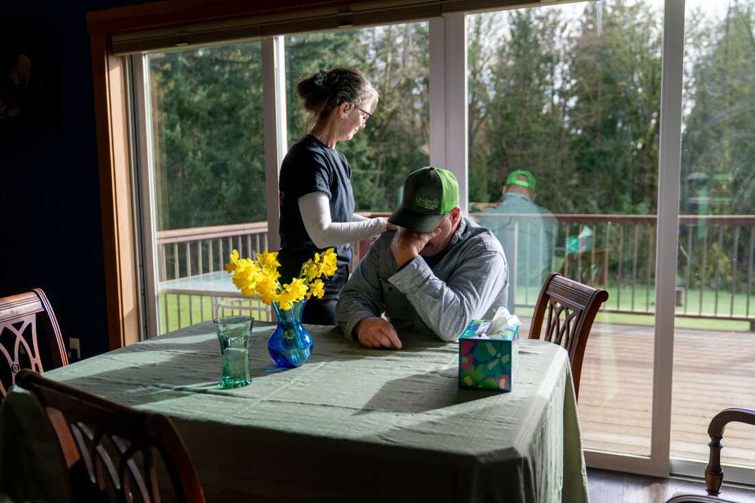 Rebecca Zuber comforts her husband Randy, on the anniversary of their daughter Sarah’s death, at their home in Rainier, Ore., on March 13, 2025. Sarah Zuber, 18, was found dead 400 feet from her front door. Six years later, her family still has no clue what happened to their daughter.
