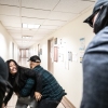 A federal agent restrains the wife of a detained man from Ecuador on Sept. 25 in New York City. The agent was later placed on leave.