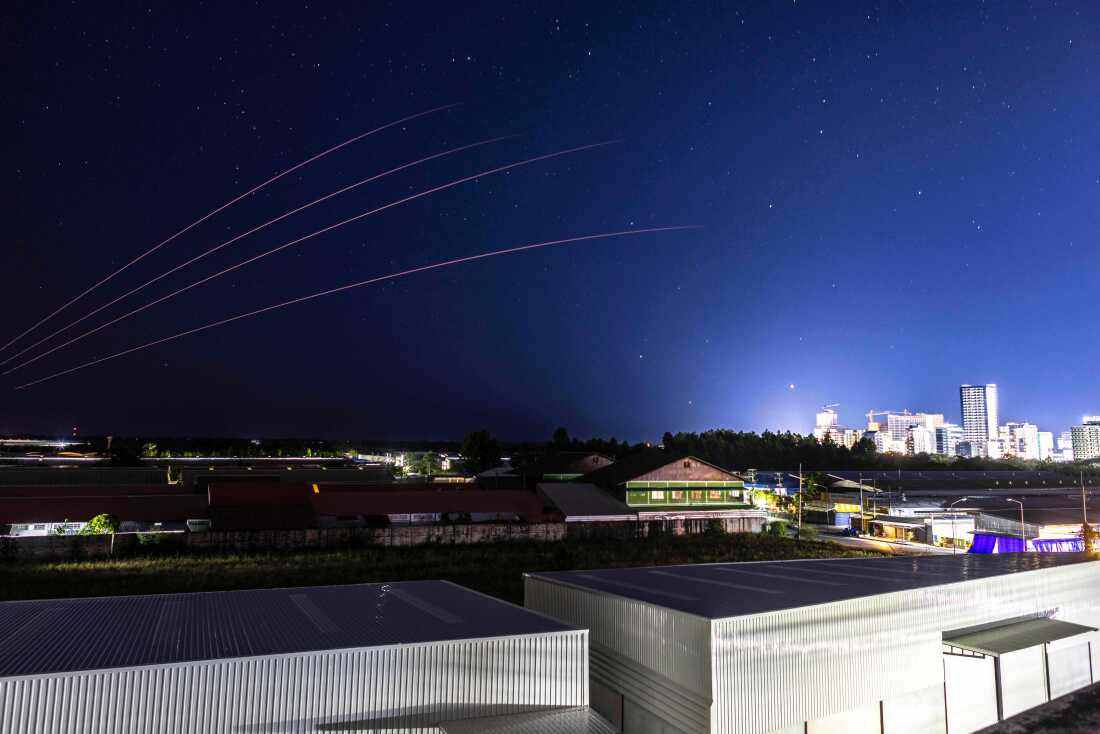 The Thai military fires artillery towards Cambodia, Friday, Dec. 26, 2025, seen from Thailand's Sa Kaeo province.