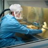 Centers for Disease Control (CDC) scientist in a protective air-tight suit handling Influenza A Virus specimens, Biosafety Level-4 (BSL-4) laboratory, Atlanta, Georgia, 2005.