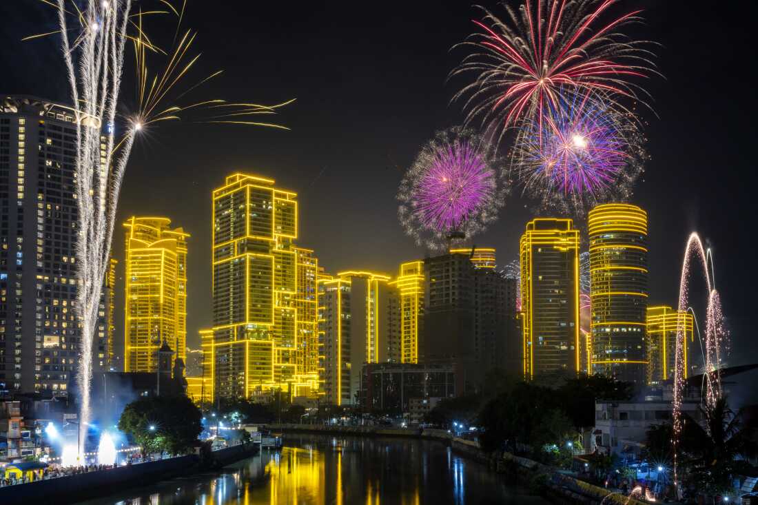 Fireworks explode over skyscrapers in Makati, Metro Manila, Philippines.  