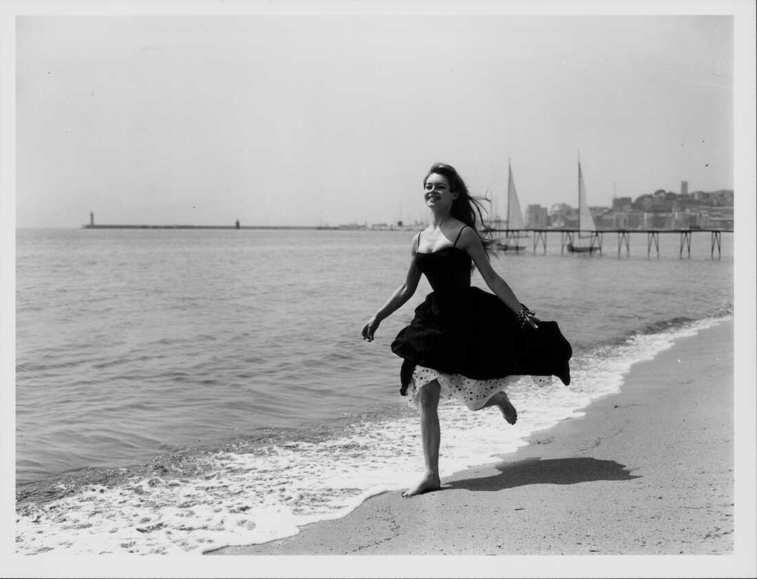 Bardot runs along the beach in Cannes, France, on April 28, 1956.