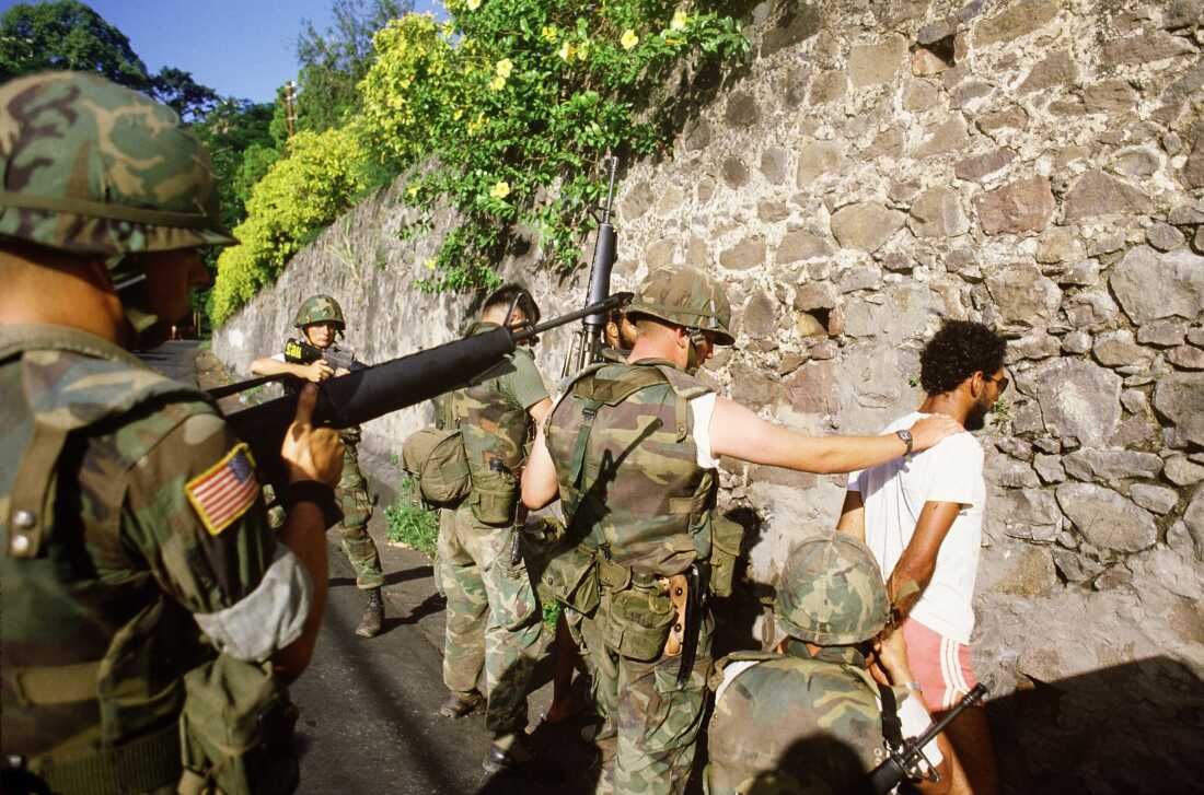U.S. soldiers arrest suspected Marxist activist in St George's, the capital of the Grenada Island, on Oct. 30, 1983, three days after American forces invaded the island, ousting the Marxist government.