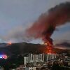 Fire at Fuerte Tiuna, Venezuela's largest military complex, is seen from a distance after a series of explosions in Caracas on January 3, 2026.