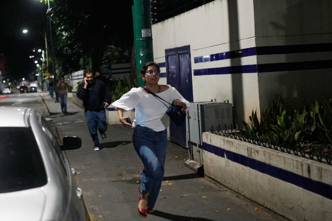 Pedestrians run after explosions and low-flying aircraft were heard in Caracas, Venezuela.