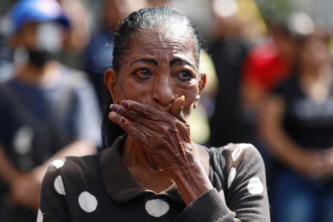A woman cries during a rally of supporters of Venezuelan President Nicolás Maduro in Caracas, Venezuela, Saturday, Jan. 3, 2026, after President Trump announced Maduro had been captured and flown out of the country.