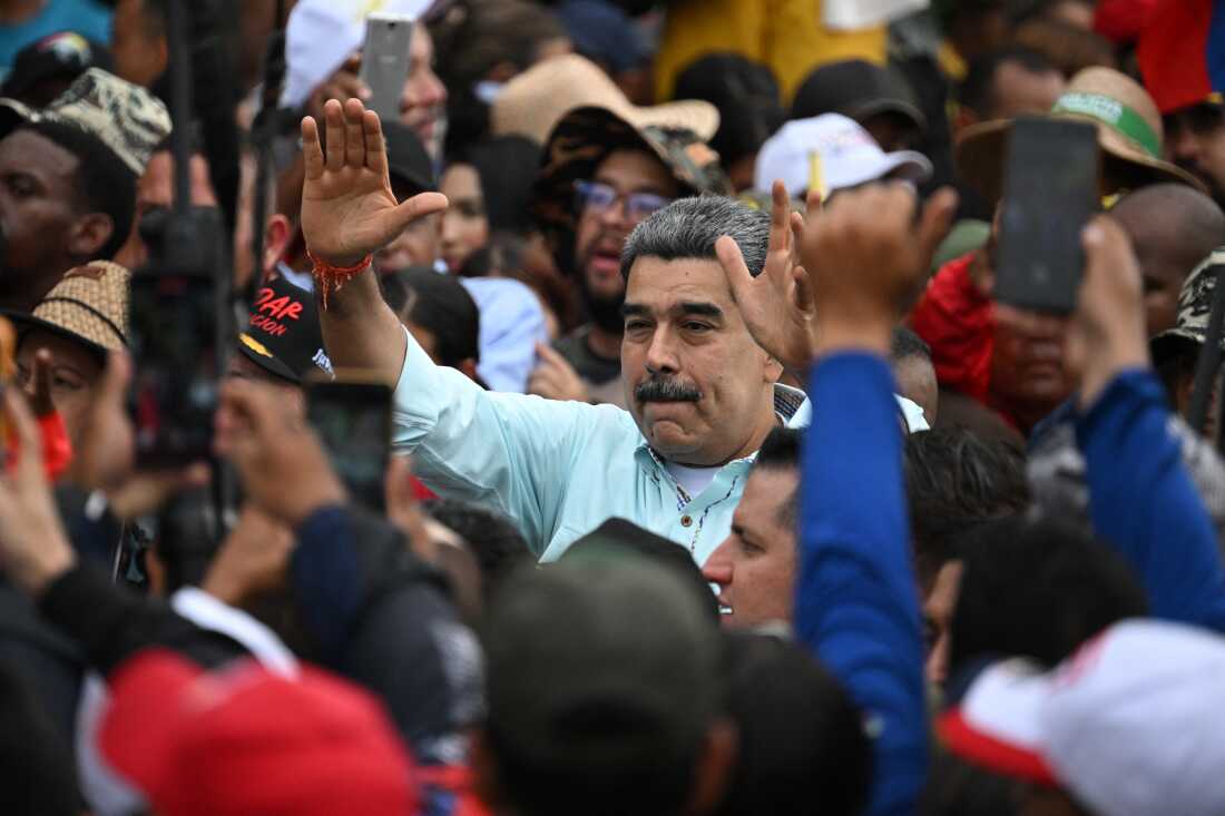 Maduro greets supporters upon his arrival at a rally in Caracas on December 10, 2025. (Photo by Federico PARRA / AFP via Getty Images)