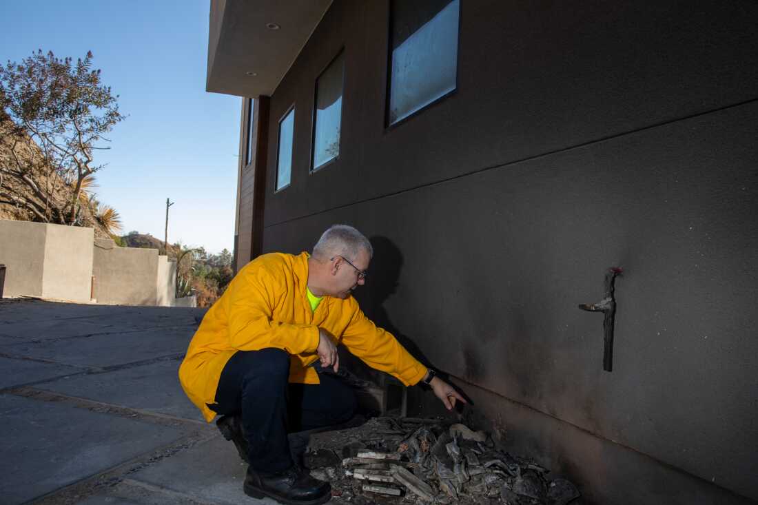 Steve Hawks of the Insurance Institute for Business & Home Safety inspects a home after the Eaton Fire. Embers caught a pile of flammable material, but the house's fire-resistant siding prevented it from spreading.