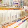 Woman checking ingredients on back of milk carton in supermarket
