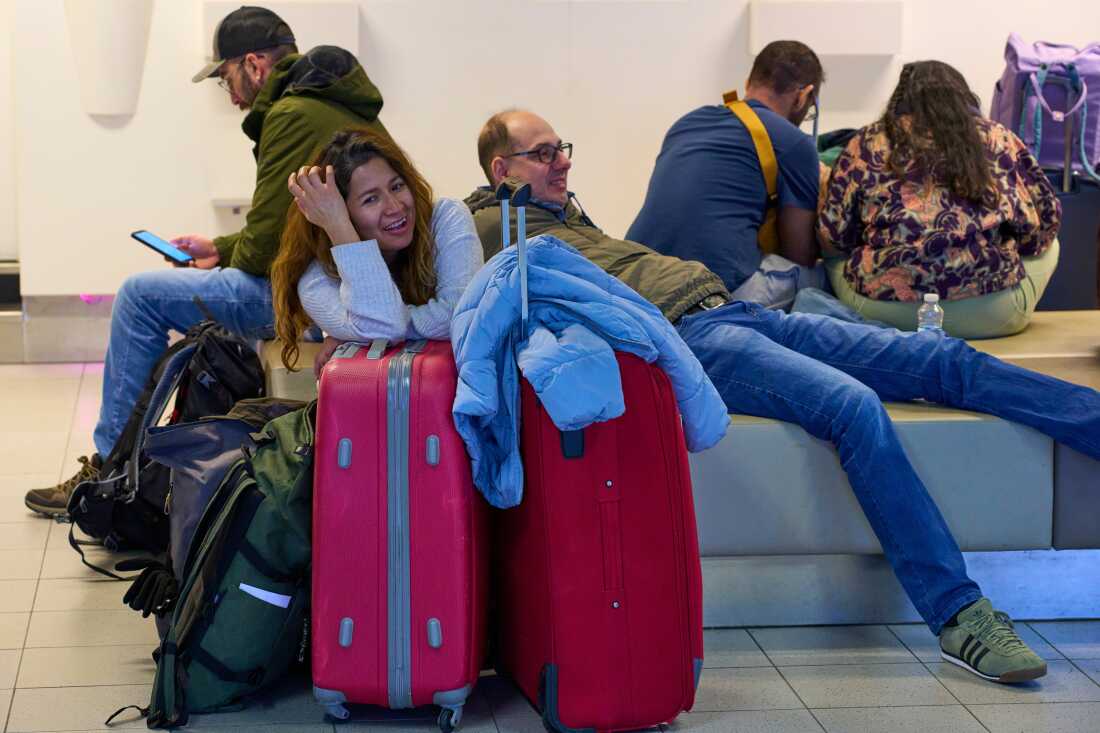 Stranded travellers wait at Schiphol airport in Amsterdam, Netherlands, Wednesday, Jan. 7, 2026, where more than 1,000 stranded passengers spent the night as snow and ice that is pummeling parts of Europe grounded hundreds of flights and choked highways and railroads. 
