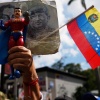 A government supporter holds an action figure of Super Bigote during a protest demanding the release of President Nicolas Maduro, who was captired by U.S. forces, in Caracas, Venezuela, Sunday, Jan. 4.